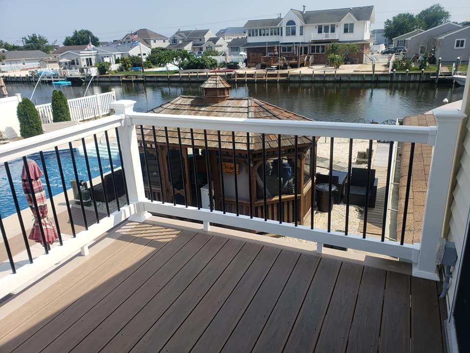 A deck overlooking a body of water with a gazebo in the background