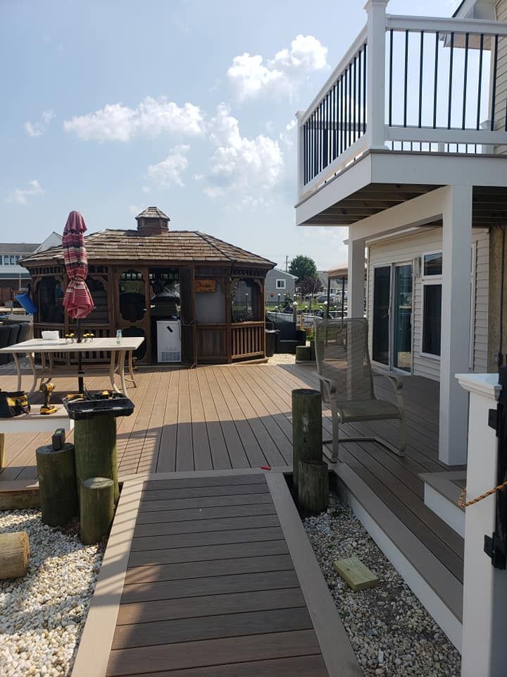A house with a deck and a gazebo in the background