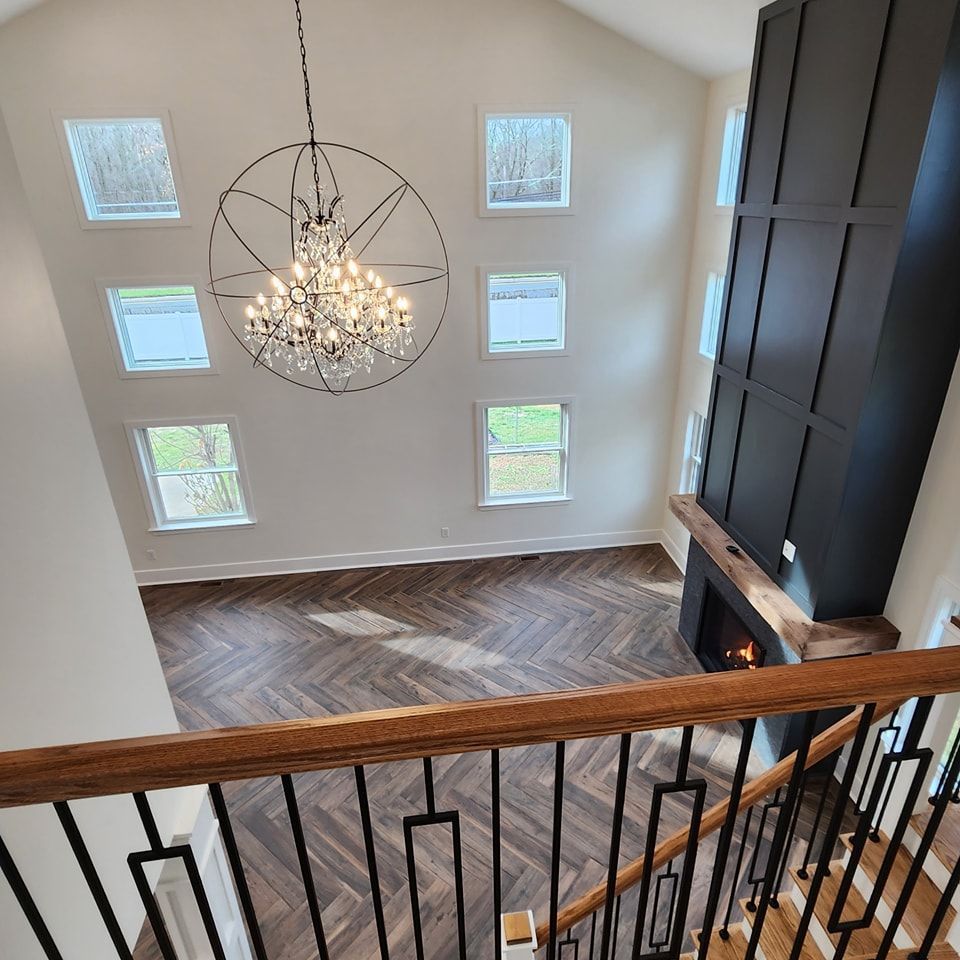 An aerial view of a living room with a chandelier hanging from the ceiling.