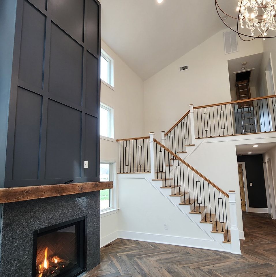 A living room with a fireplace and stairs