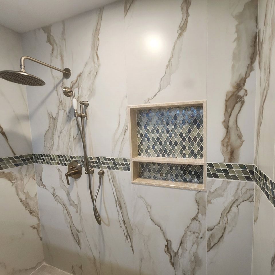 A shower with marble walls and a shower head