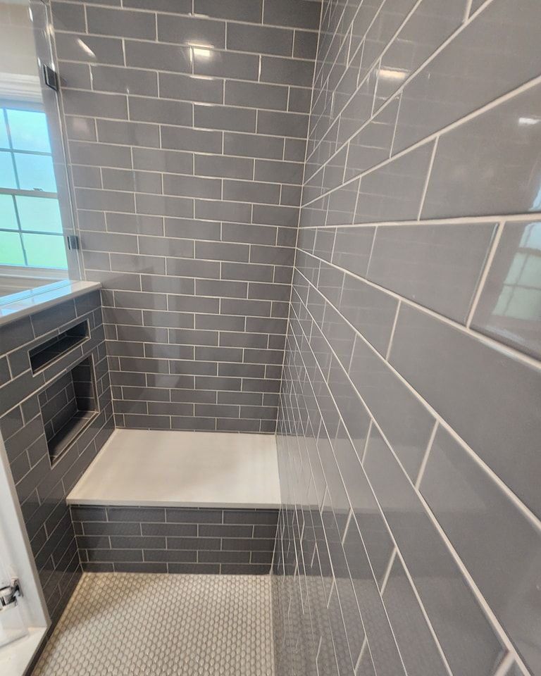 A bathroom with gray tiles