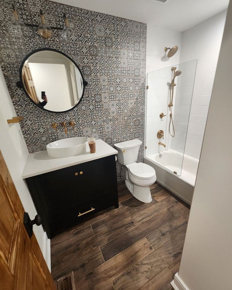 A bathroom with a toilet, sink, and bathtub