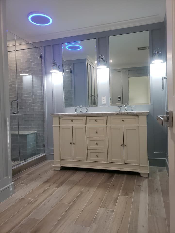 A bathroom with two sinks and a walk-in shower