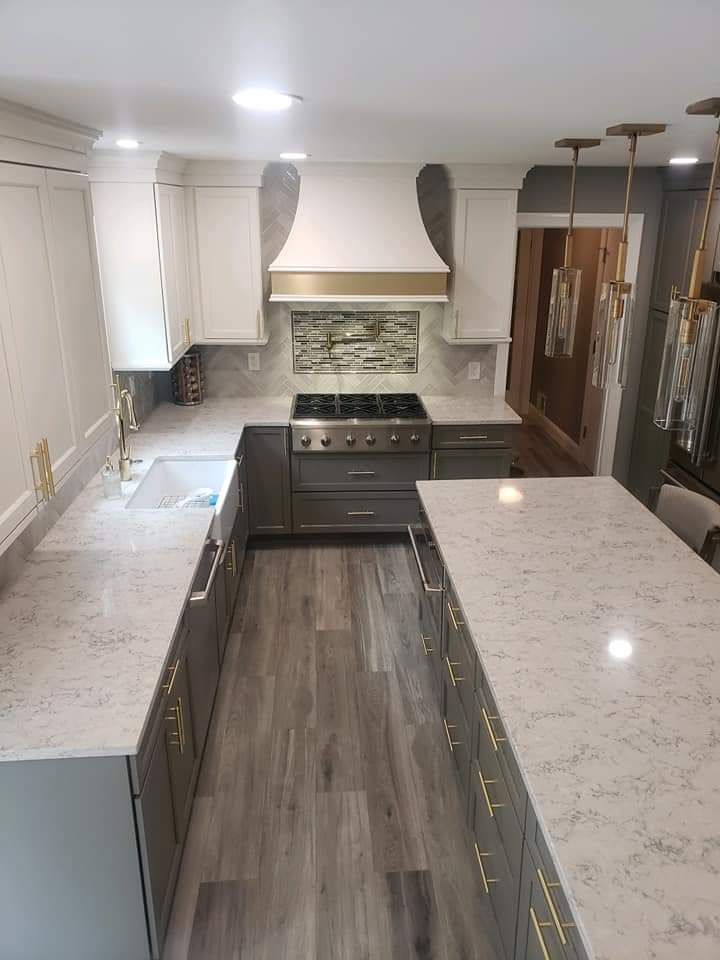 A kitchen with a stove, sink, and countertops