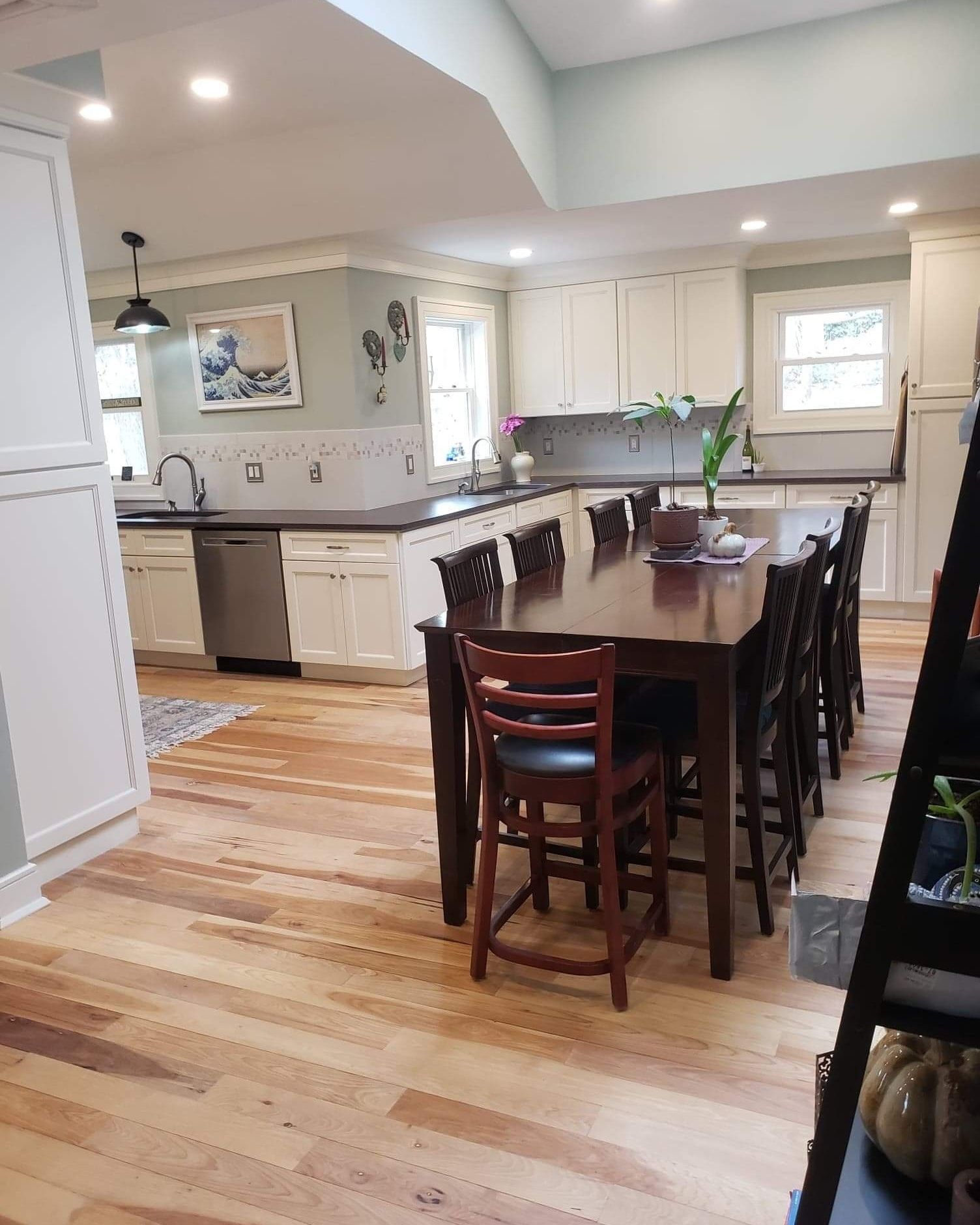 A kitchen with a dining table and chairs in it