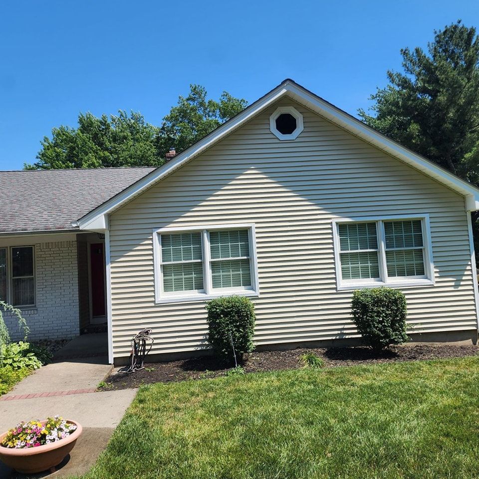 A house with a roof that has a round window on it