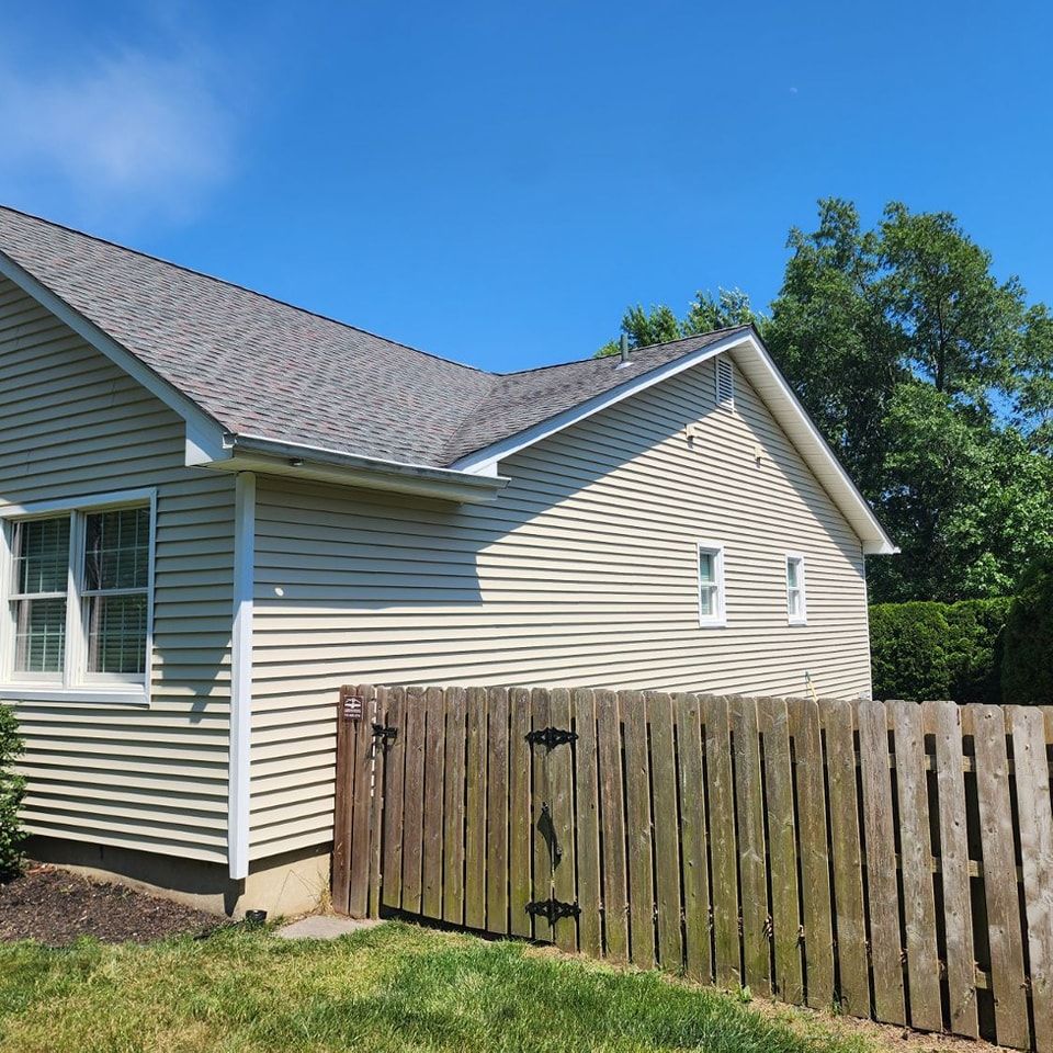 A house with a wooden fence in front of it