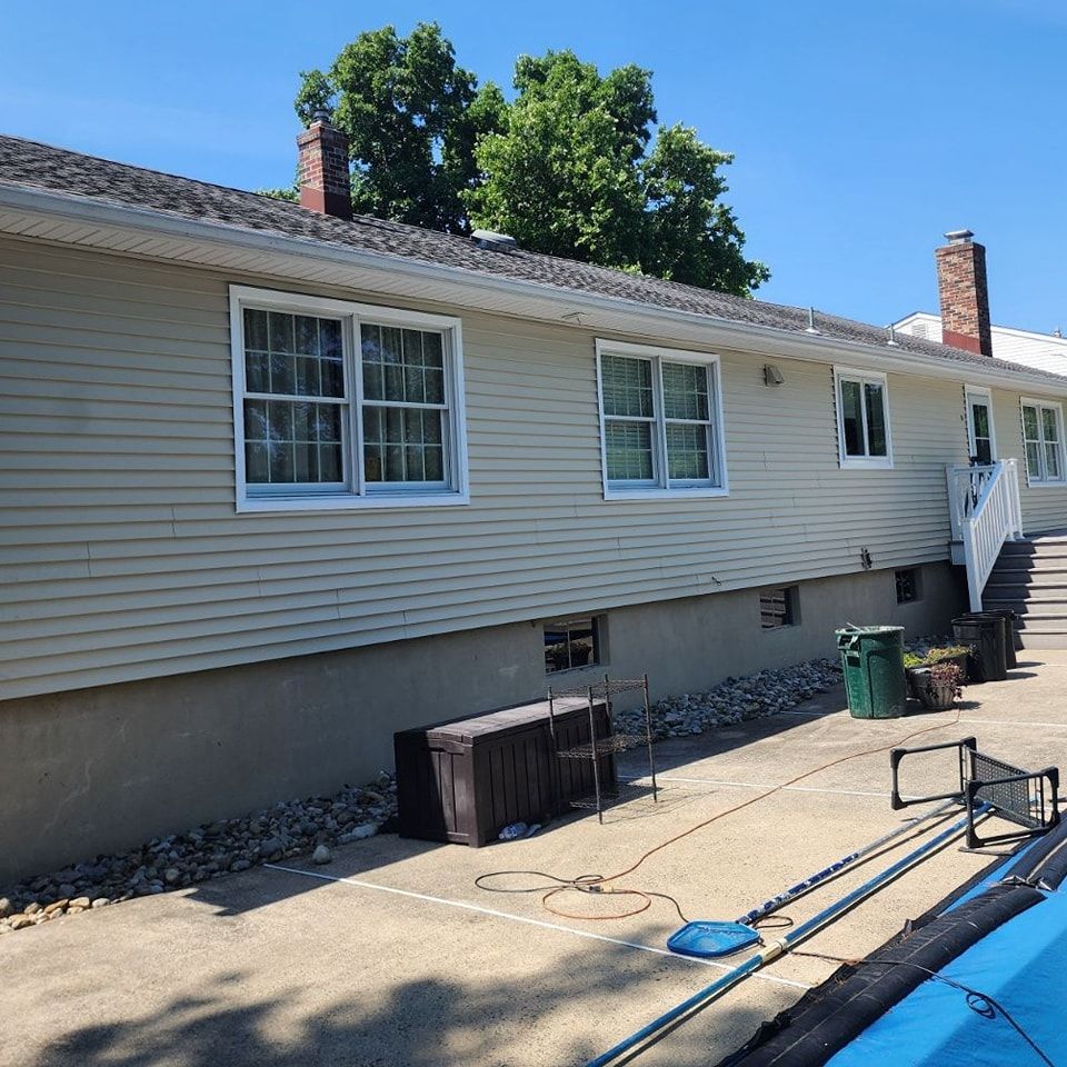 A house with a swimming pool in front of it