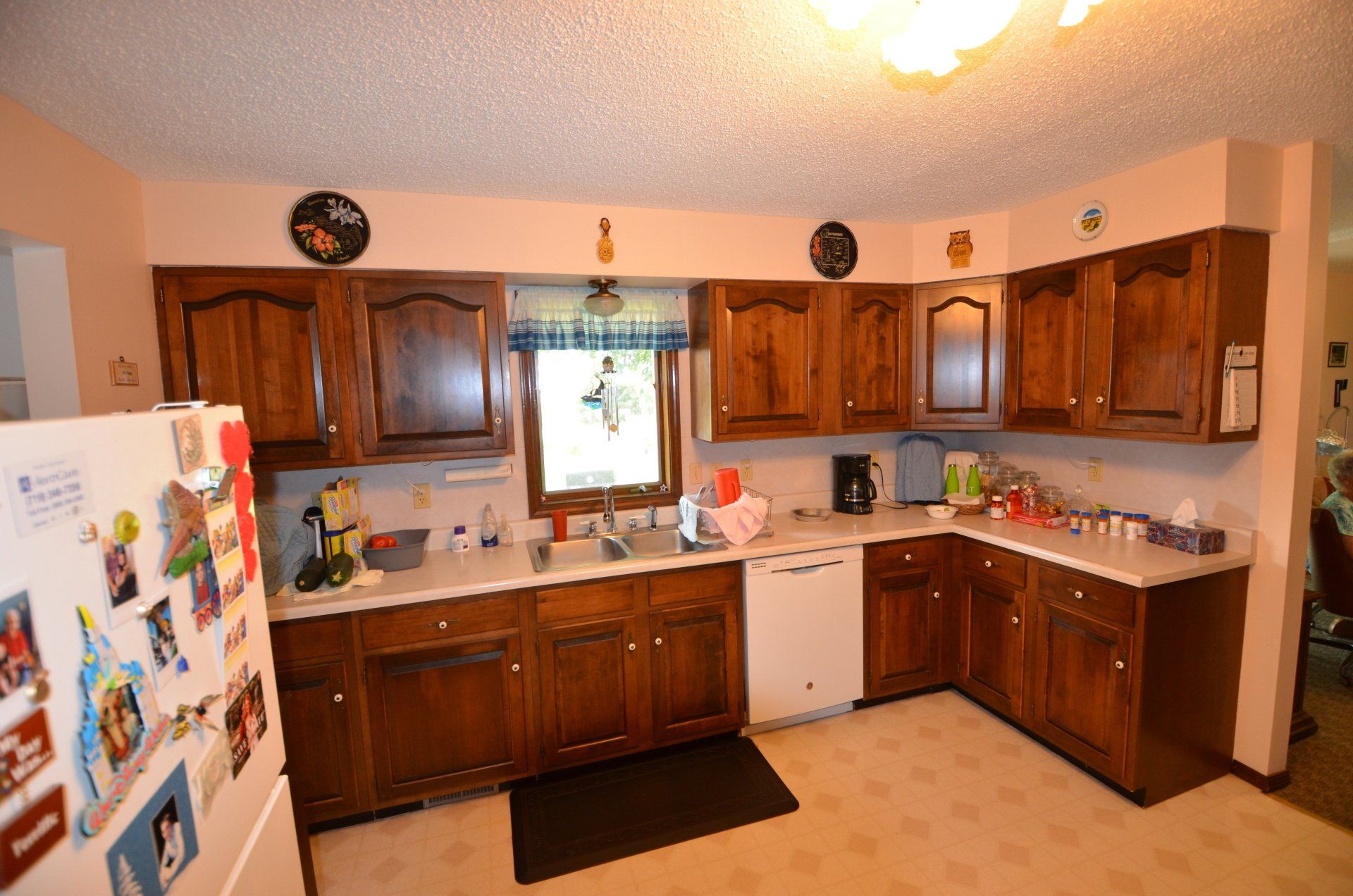 A kitchen with wooden cabinets and a white refrigerator