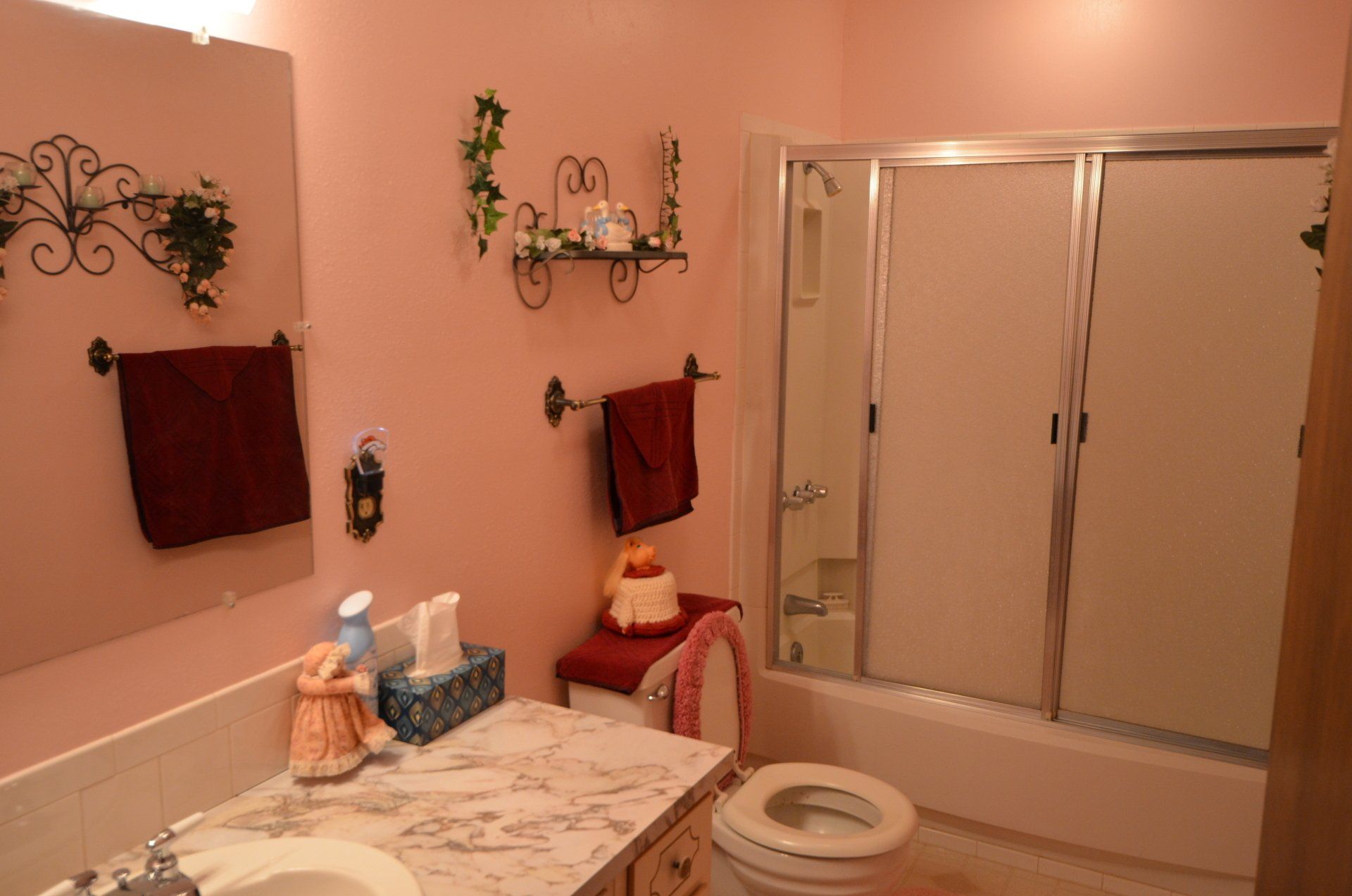 A bathroom with a toilet a sink and a shower