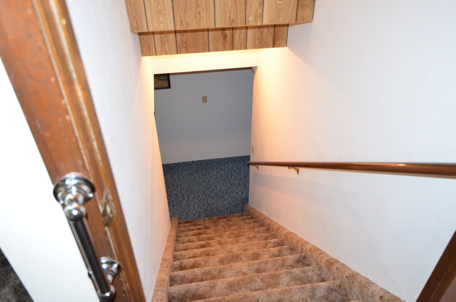 A set of stairs leading up to the basement of a house