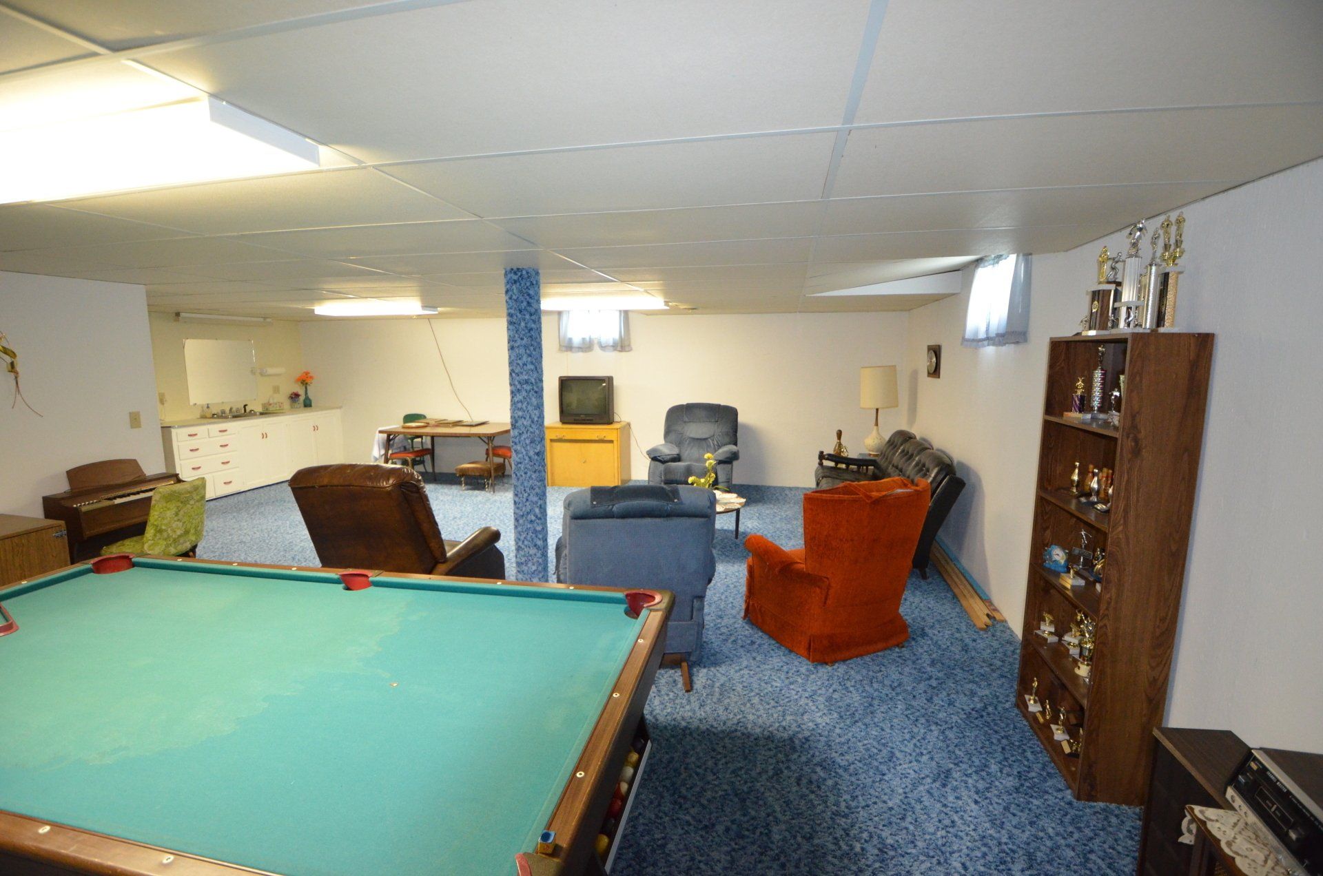 A pool table is in the middle of a living room