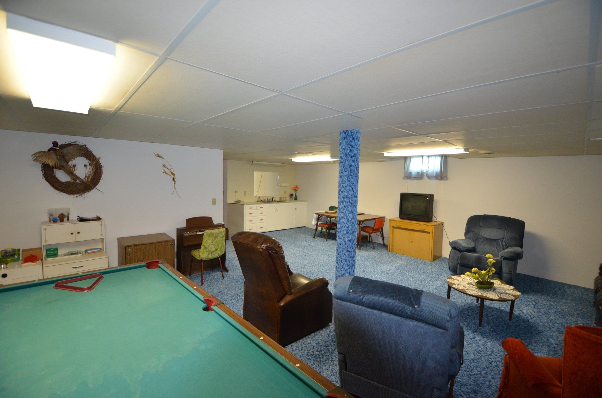 There is a pool table in the middle of the room.