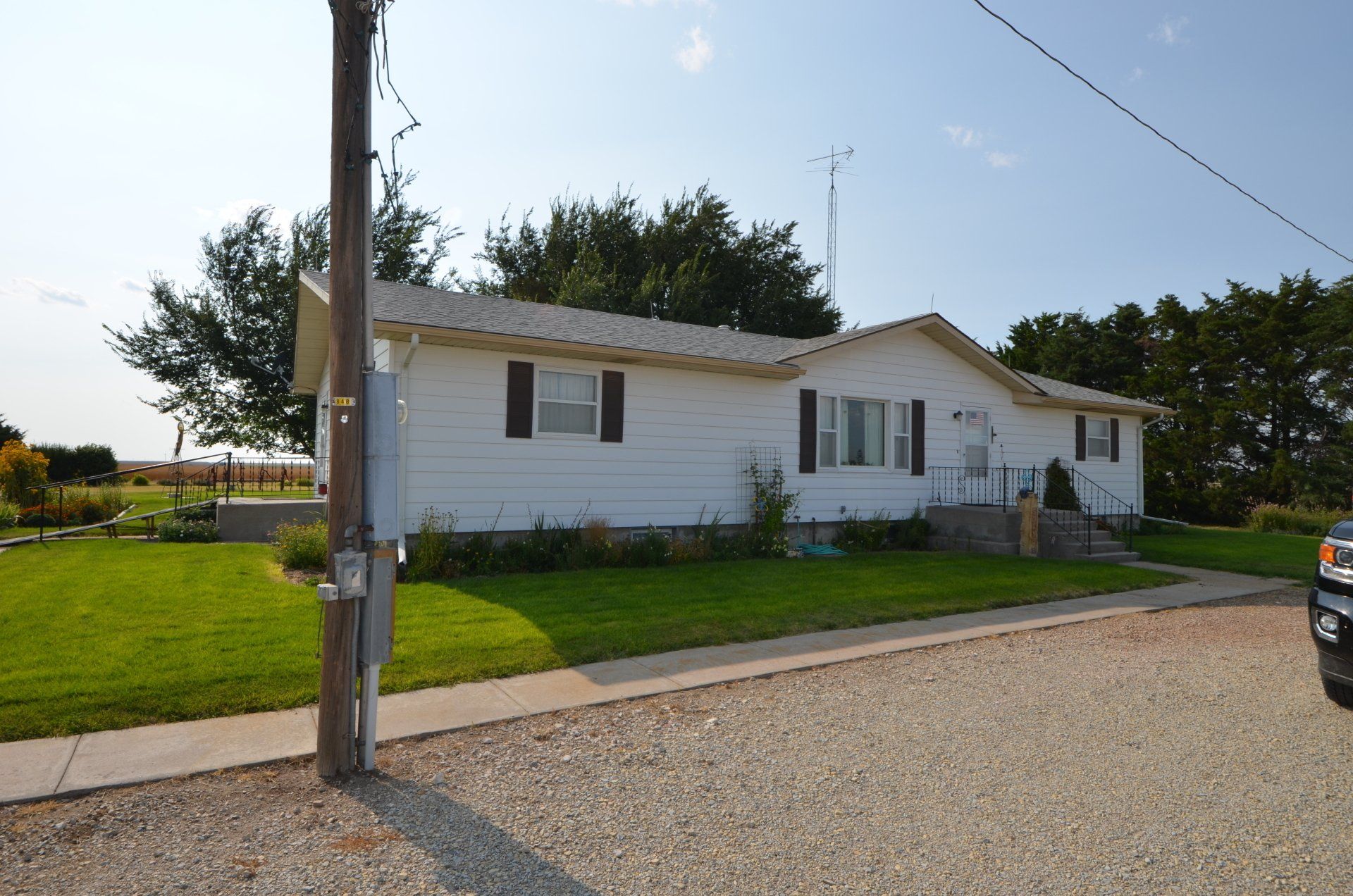 A truck is parked in front of a white house