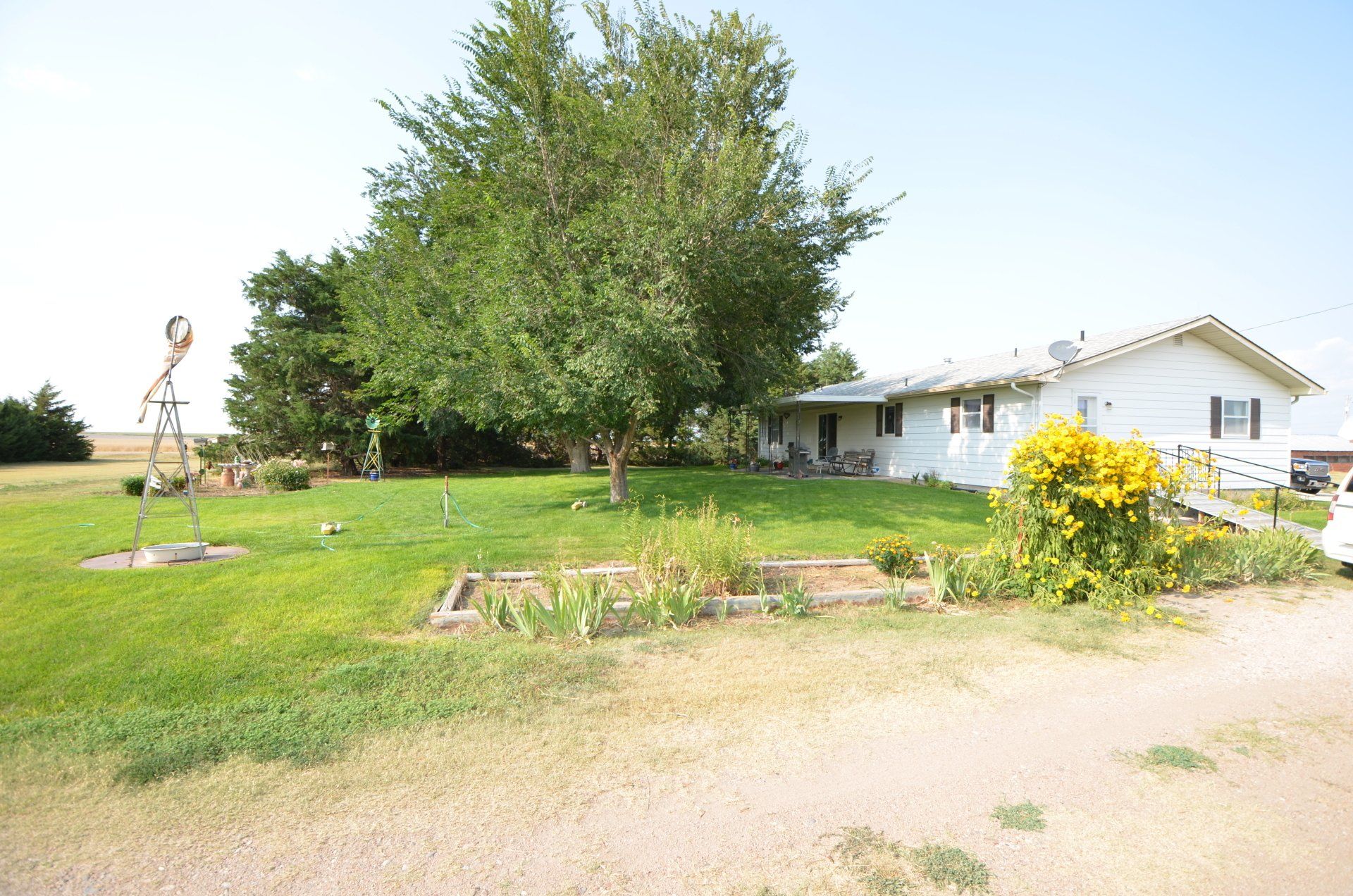 A white house with a statue in front of it