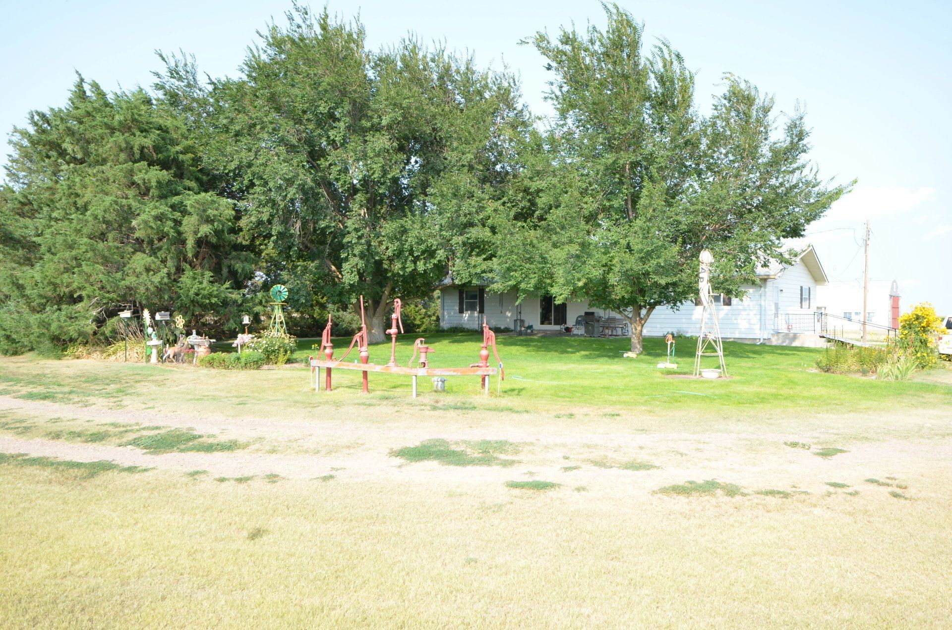 A white house with a lot of trees in front of it