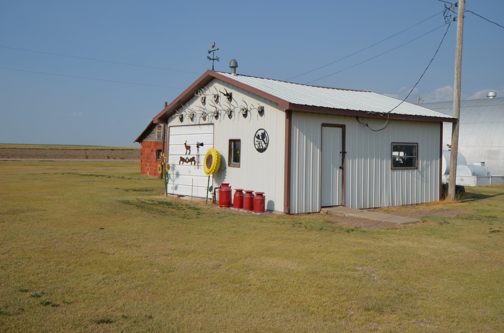 A white building with red barrels in front of it