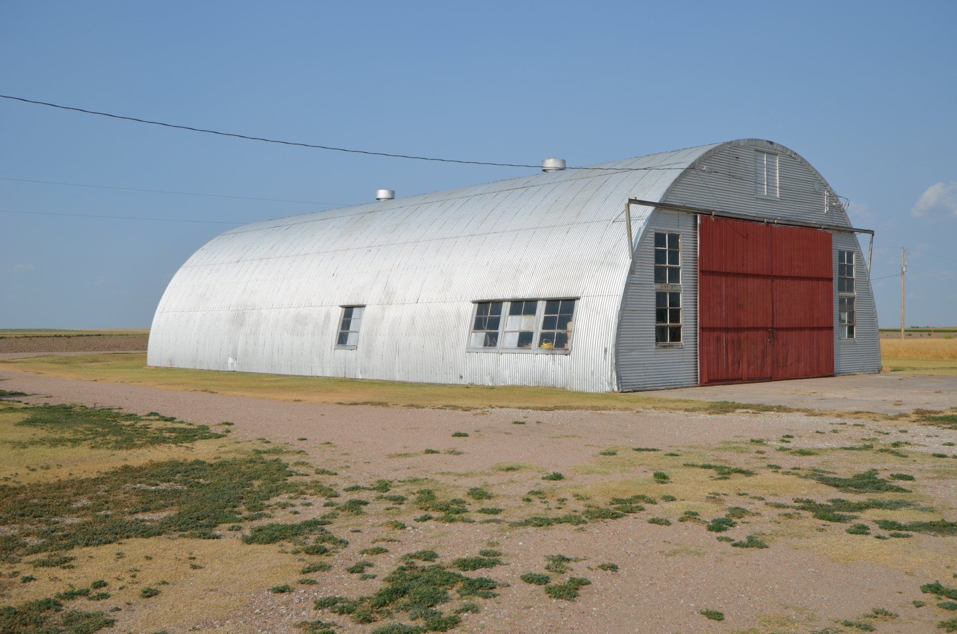 A large white building with a red door and the letter e on the side