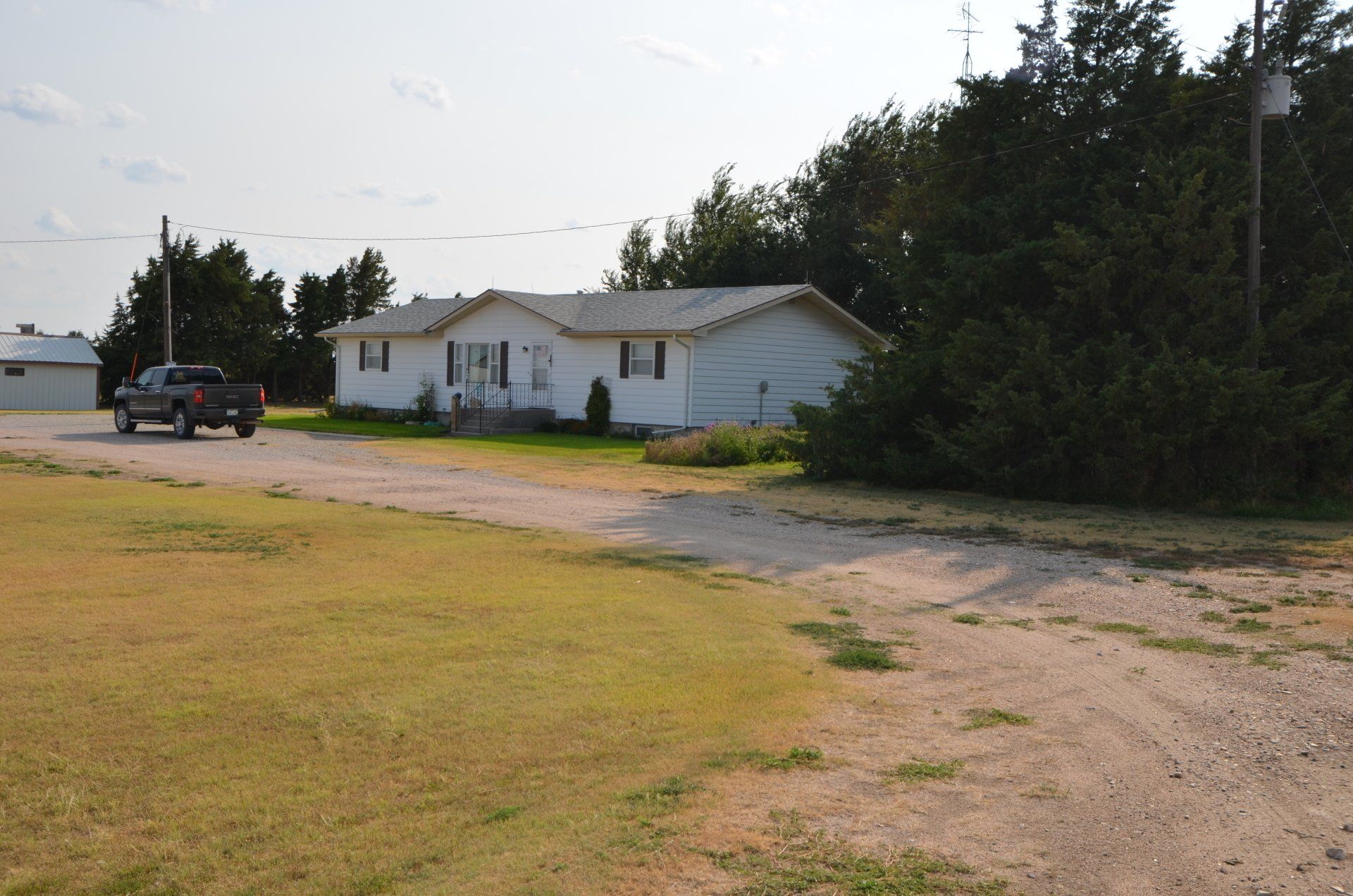 A truck is parked in front of a white house