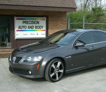 Car in front of Precision Auto and Body