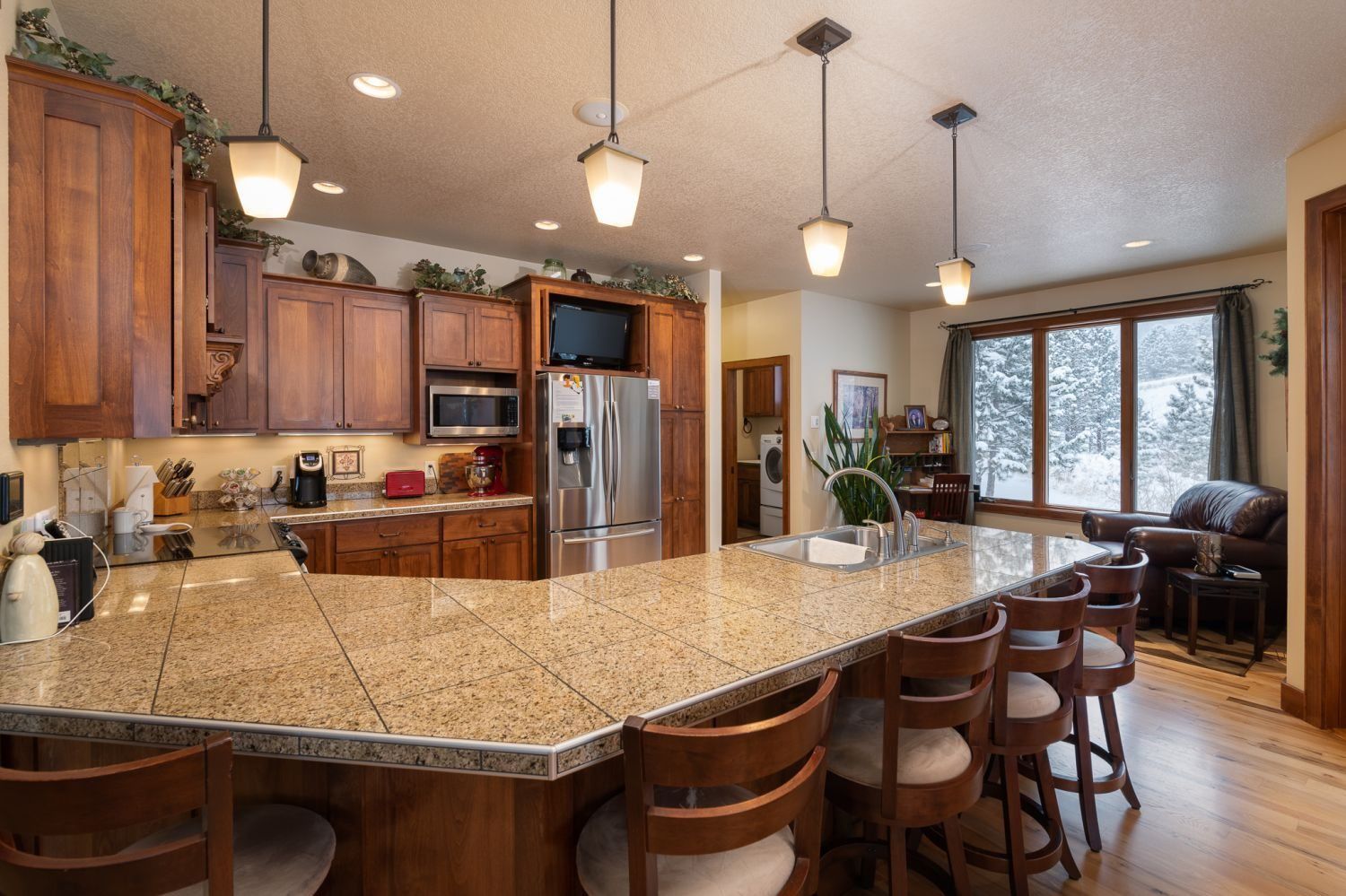 A kitchen with granite counter tops and wooden cabinets
