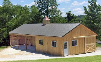 a row of horse stables with a red roof