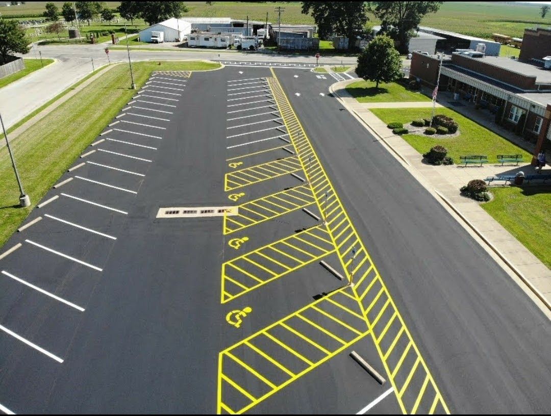 Empty parking lot with yellow no-parking markings and diagonal striped zones.