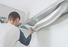 Man fixing a ventilation system