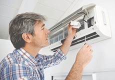 Man repairing an air conditioning unit