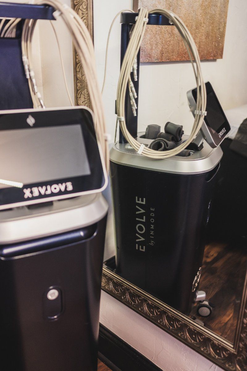 A evolve machine is sitting on a table next to a mirror.