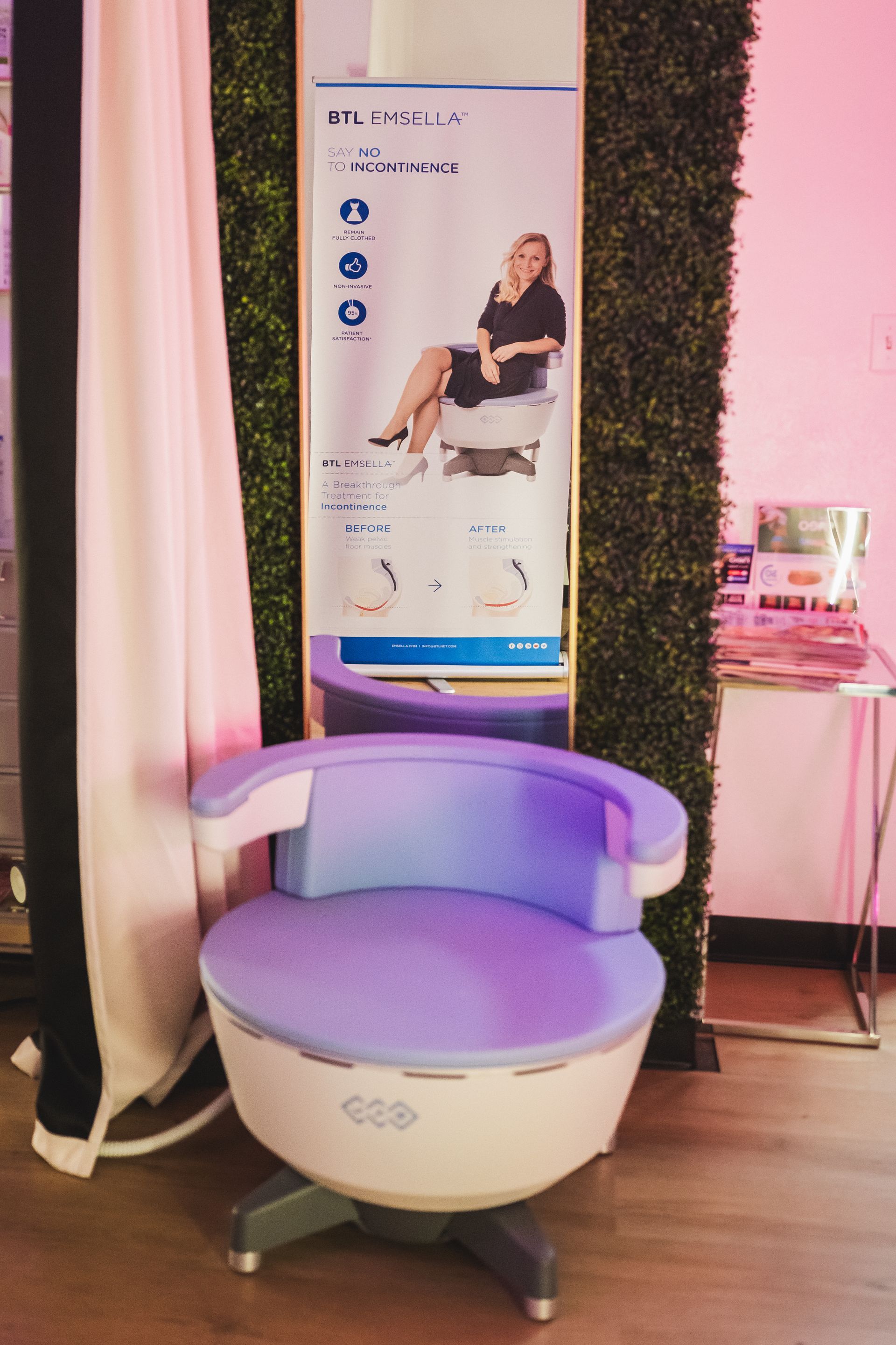 A woman is sitting in a chair in front of a mirror.