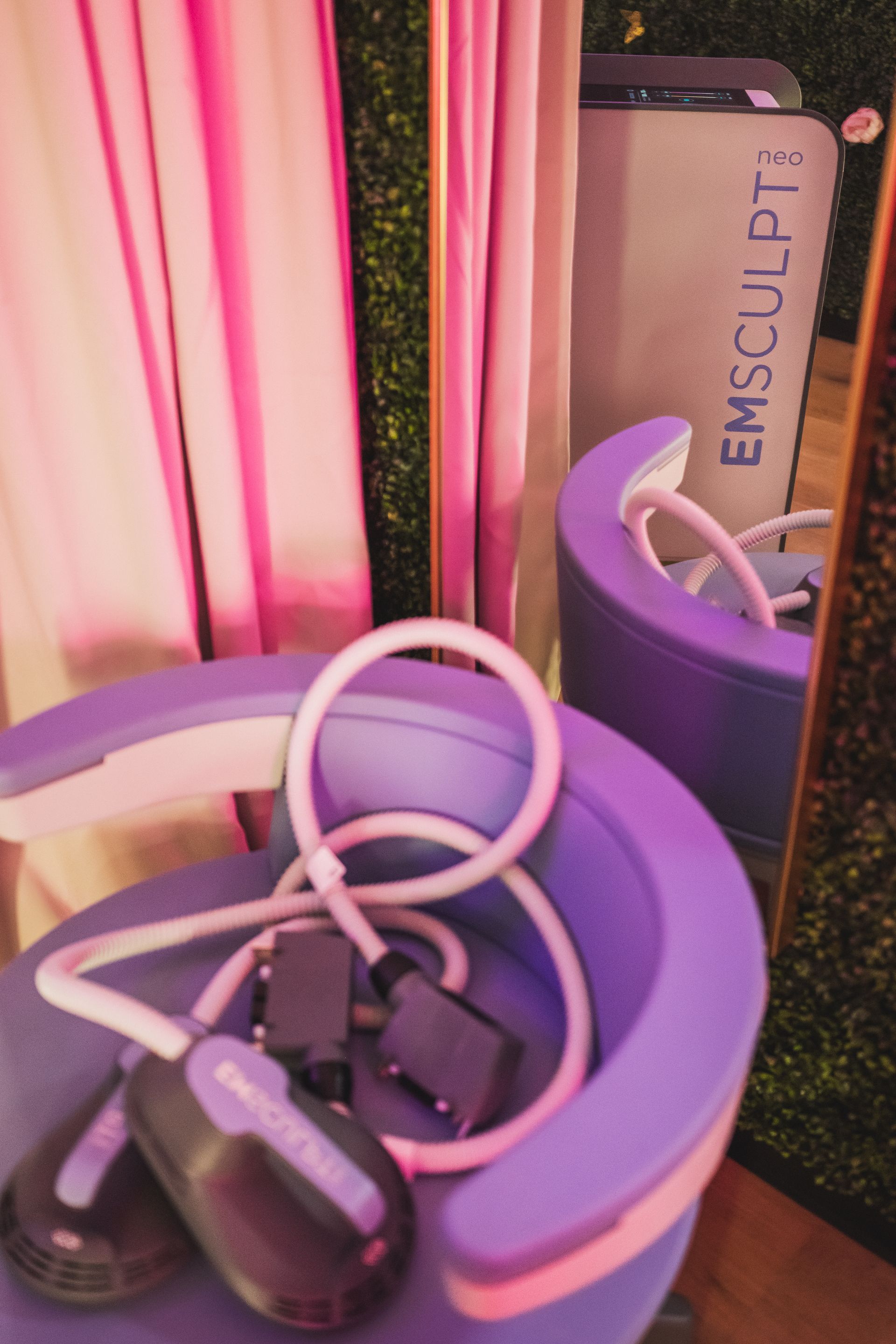 A purple chair with emsculpt written on it