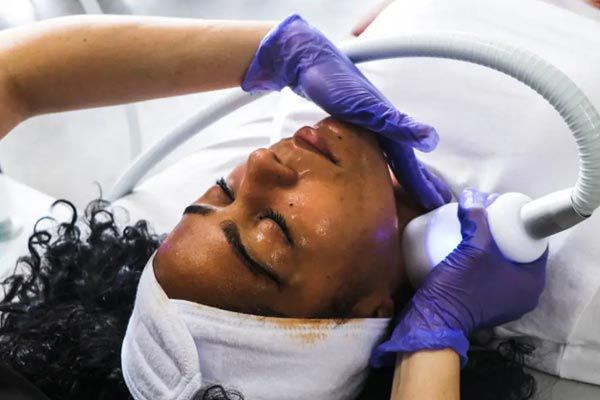 A woman is getting a t-shock treatment.