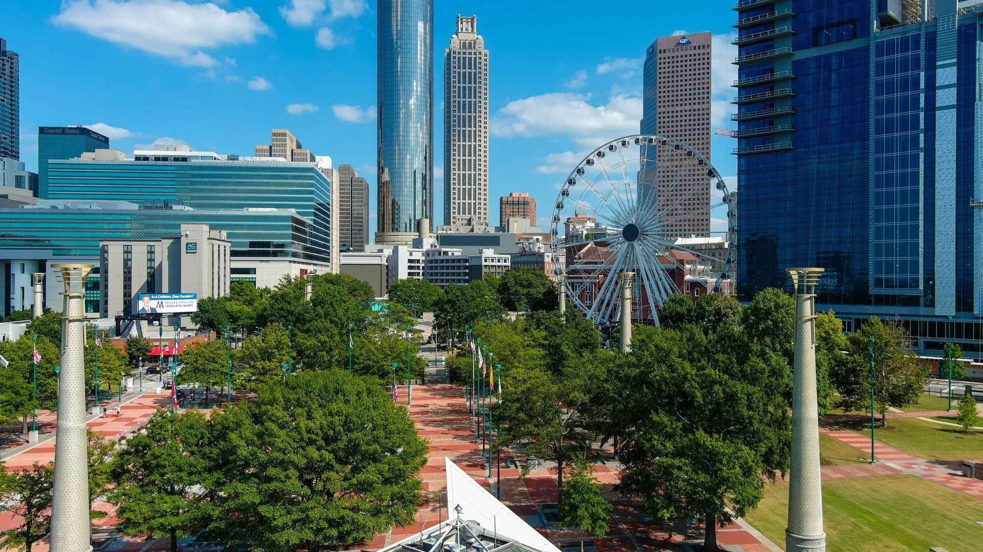 Aerial view of Centennial Olympic Park in Atlanta, with the SkyView ferris wheel and city skyscrapers in the background.