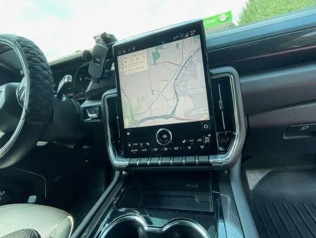 Interior view of a vehicle dashboard featuring a large, vertical touchscreen display showing a digital map.