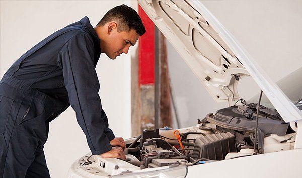 Man checking car engine