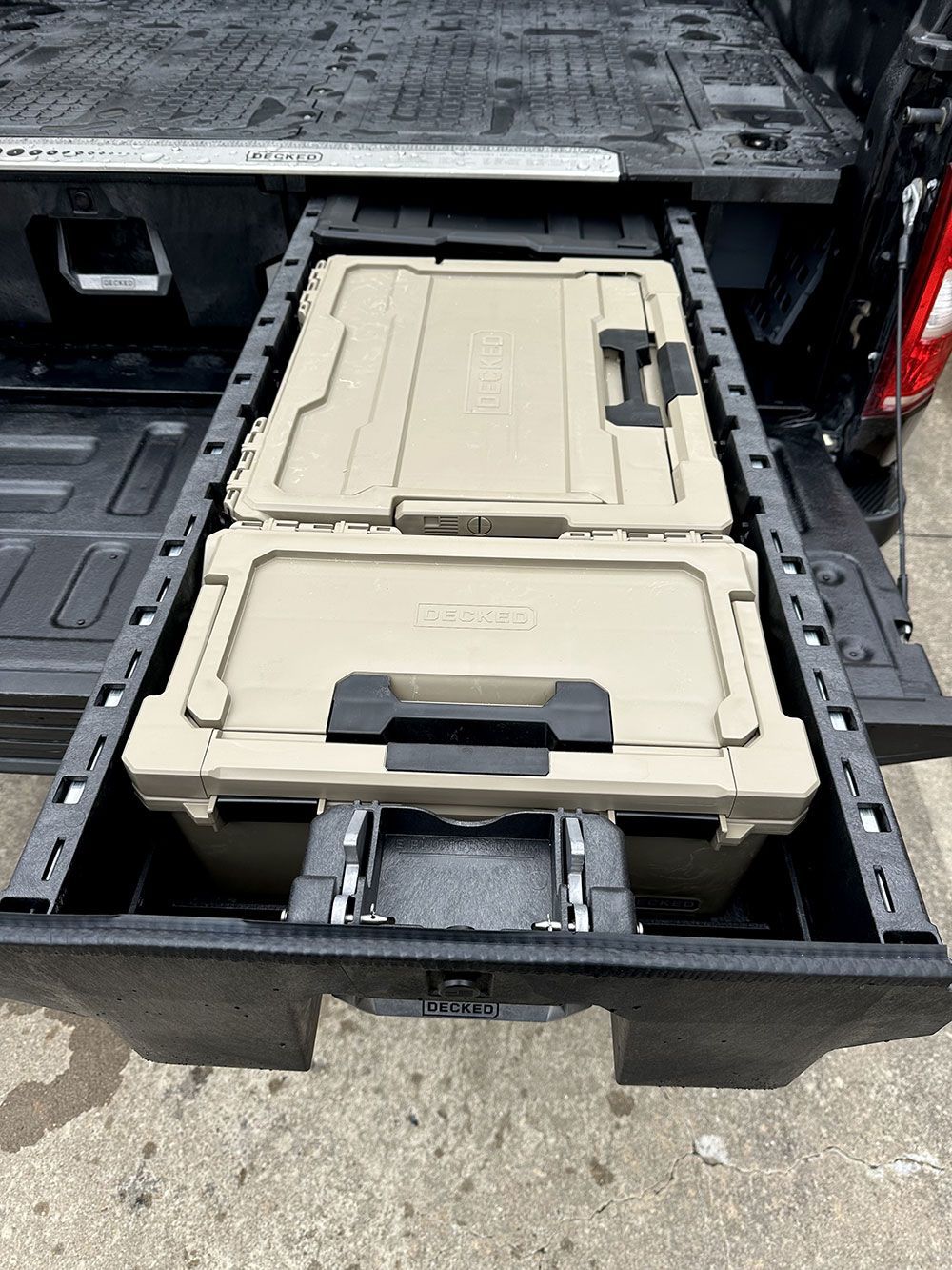 Two tan coolers in a truck bed sliding drawer system.