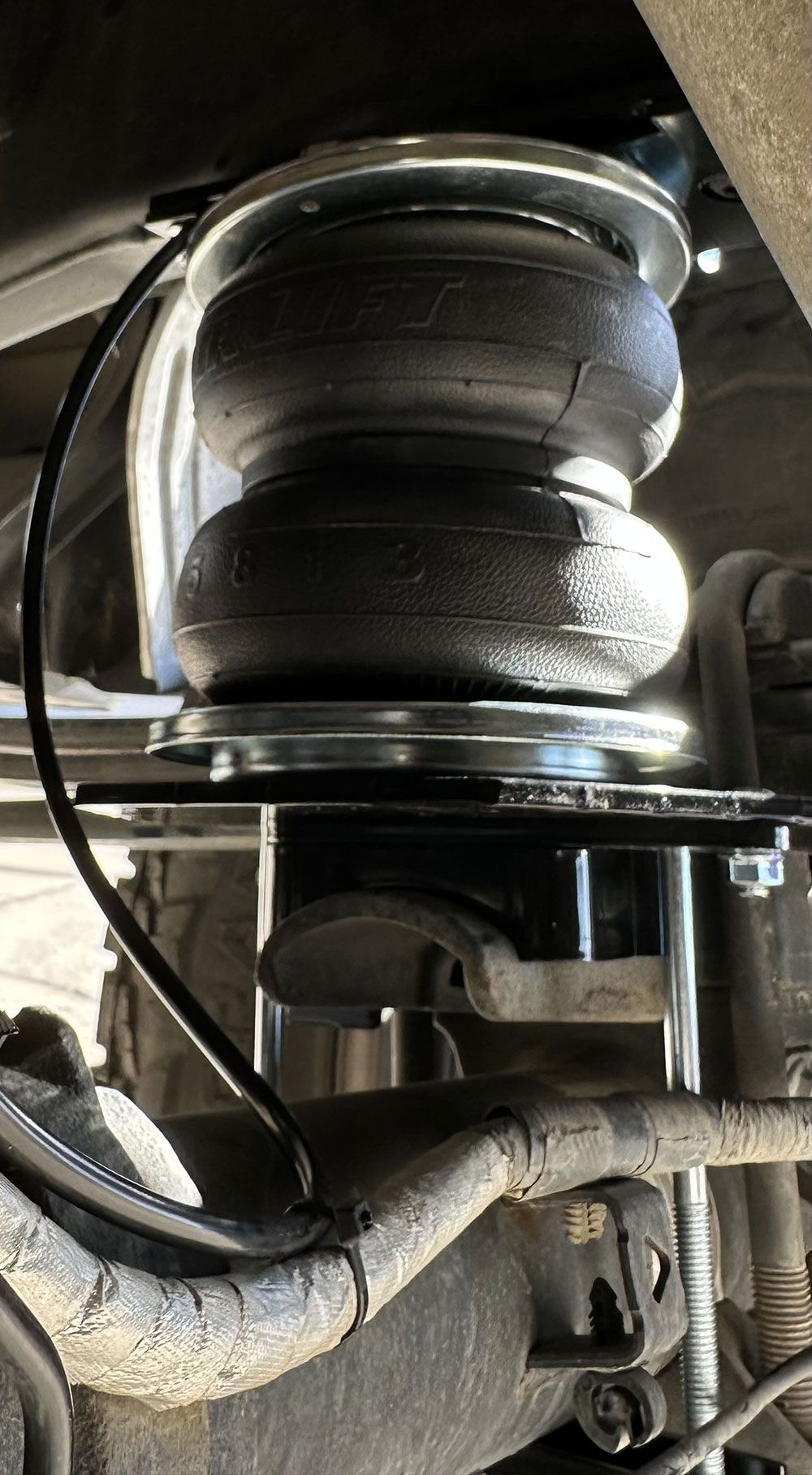 Airbag suspension system installed on a vehicle's rear axle.