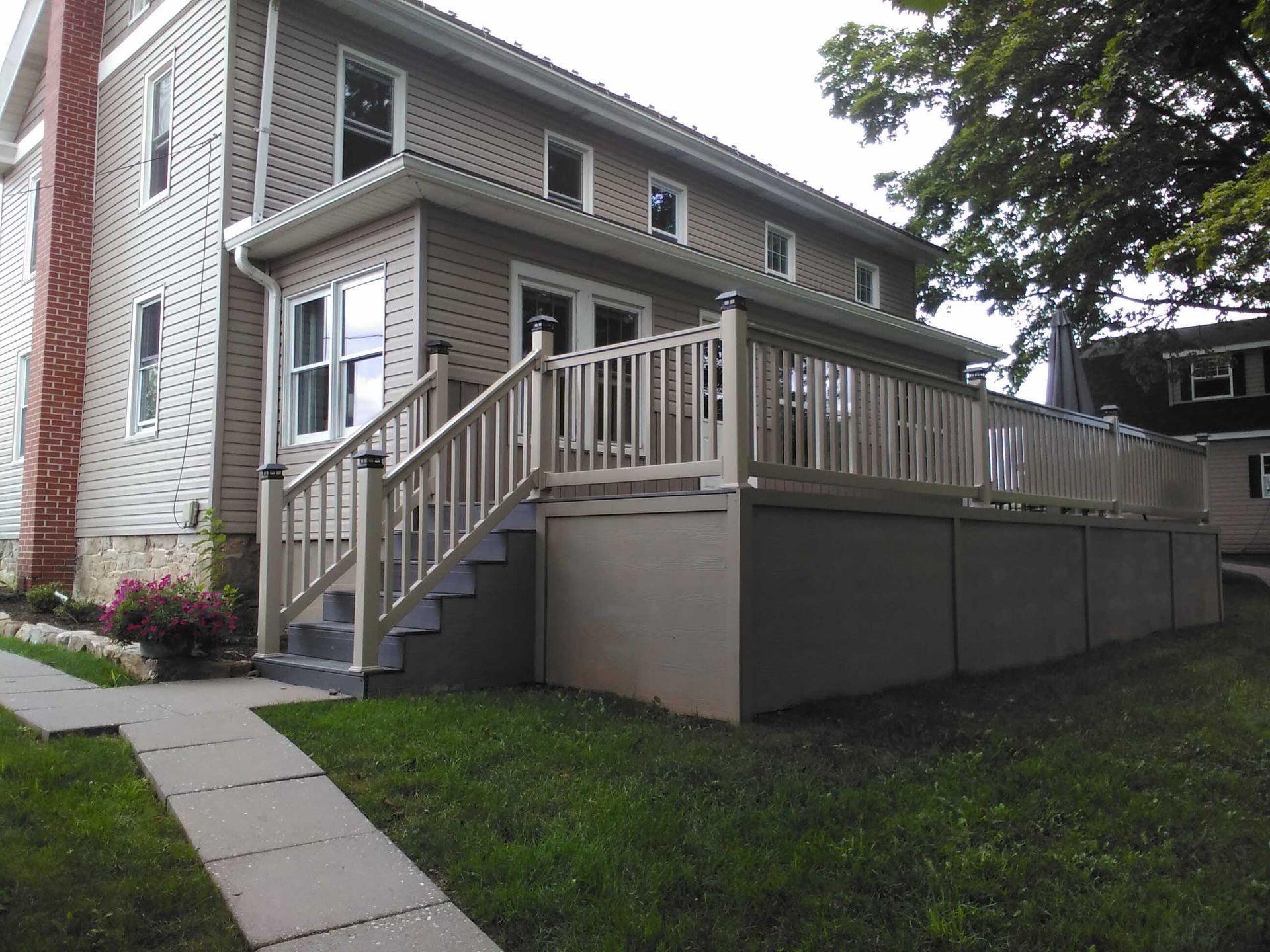 A house with a large deck and stairs leading up to it