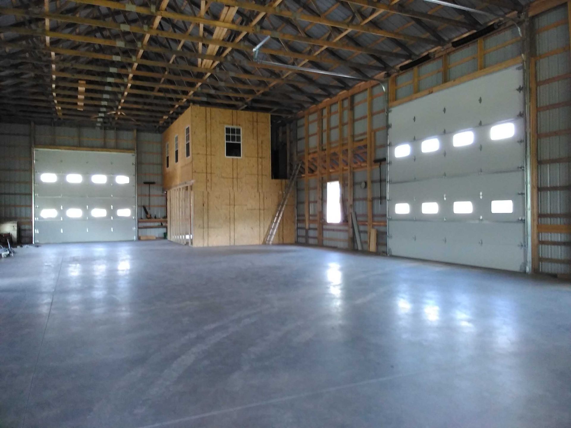 A large empty building with a lot of garage doors