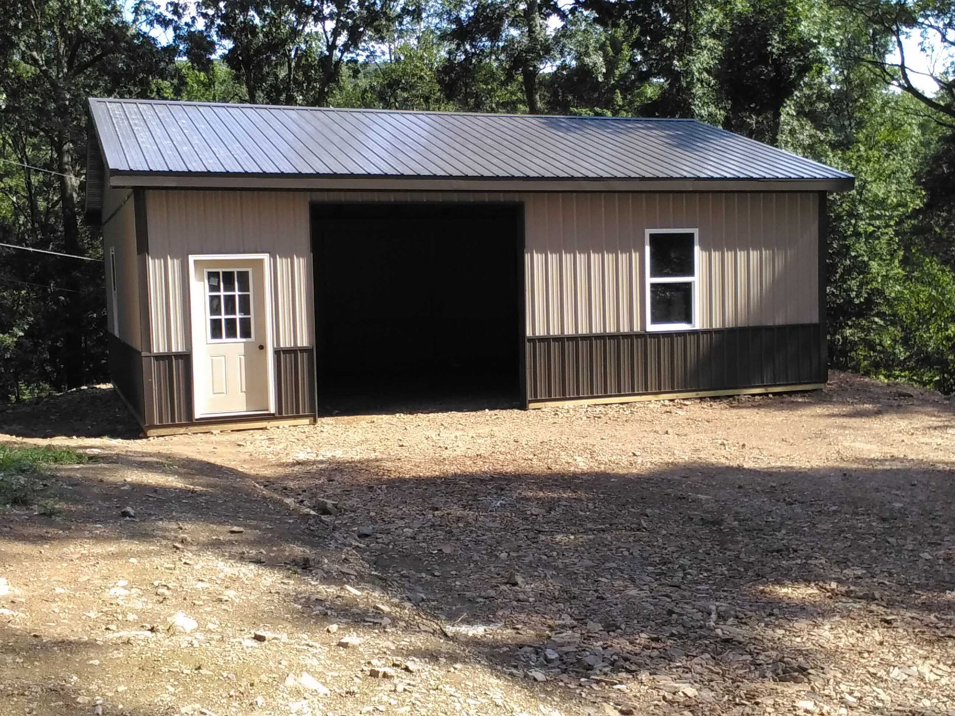 A garage with a metal roof and a white door