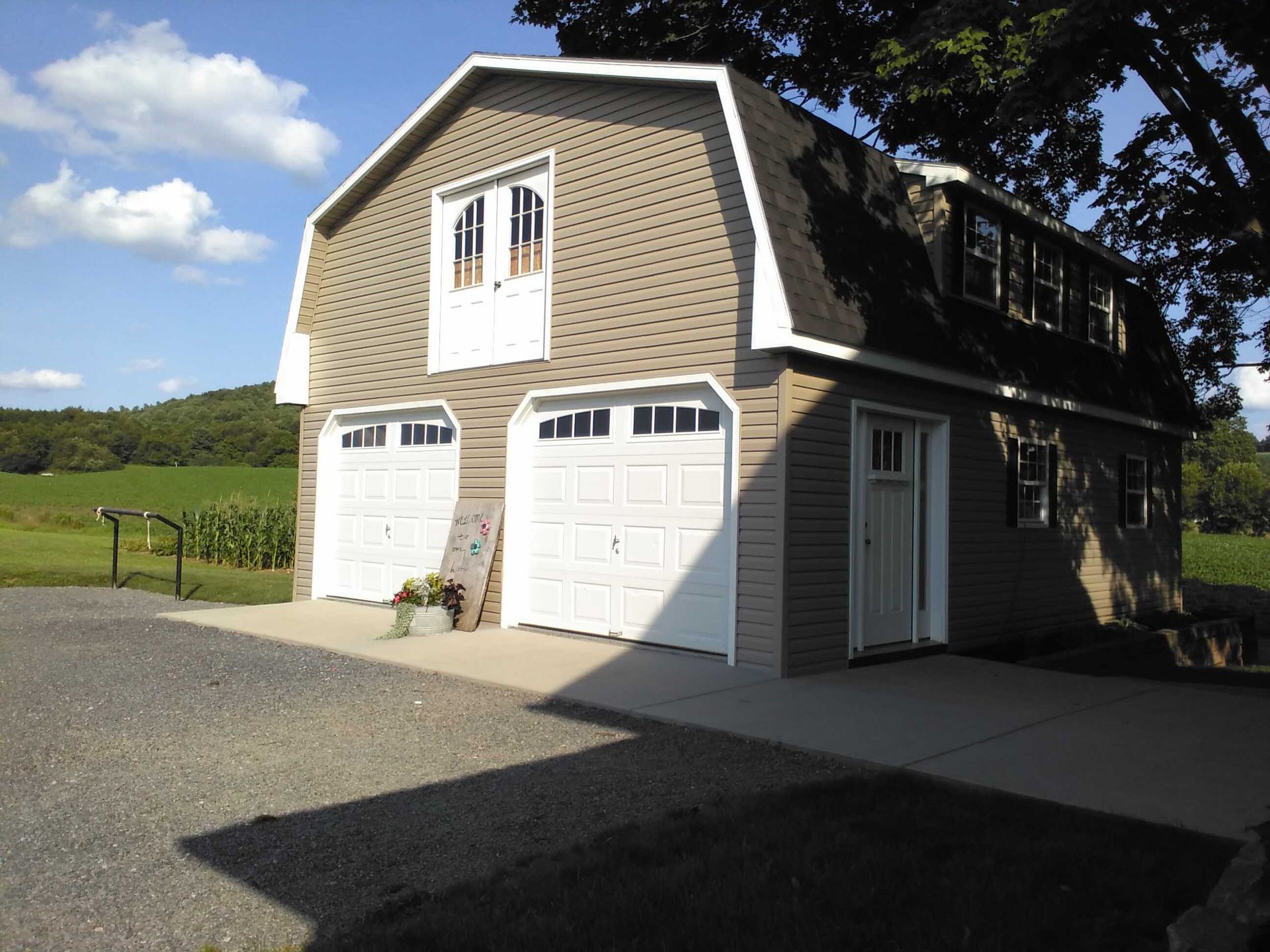 A large barn shaped garage with two garage doors