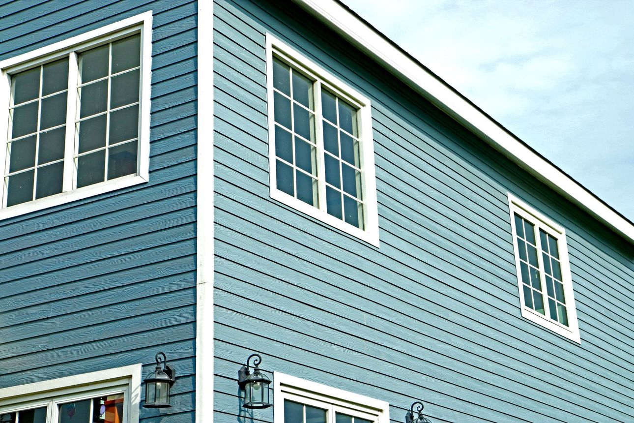 A blue house with white trim and a lot of windows