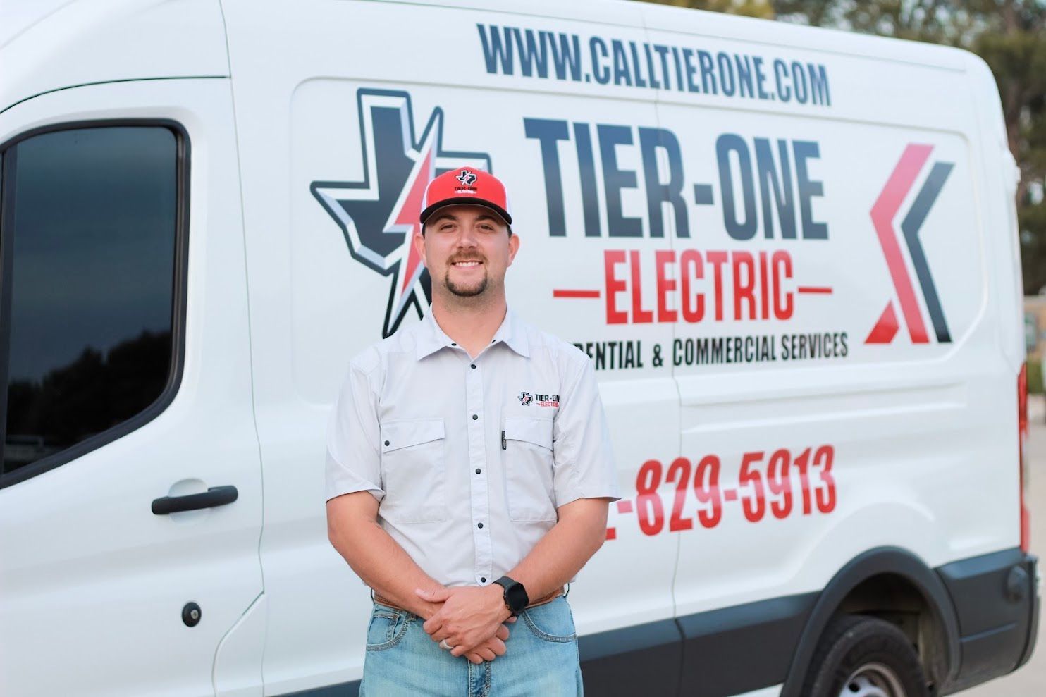 Tier-One Electric business owner standing in front of a branded electrical service van in Grapevine, TX.