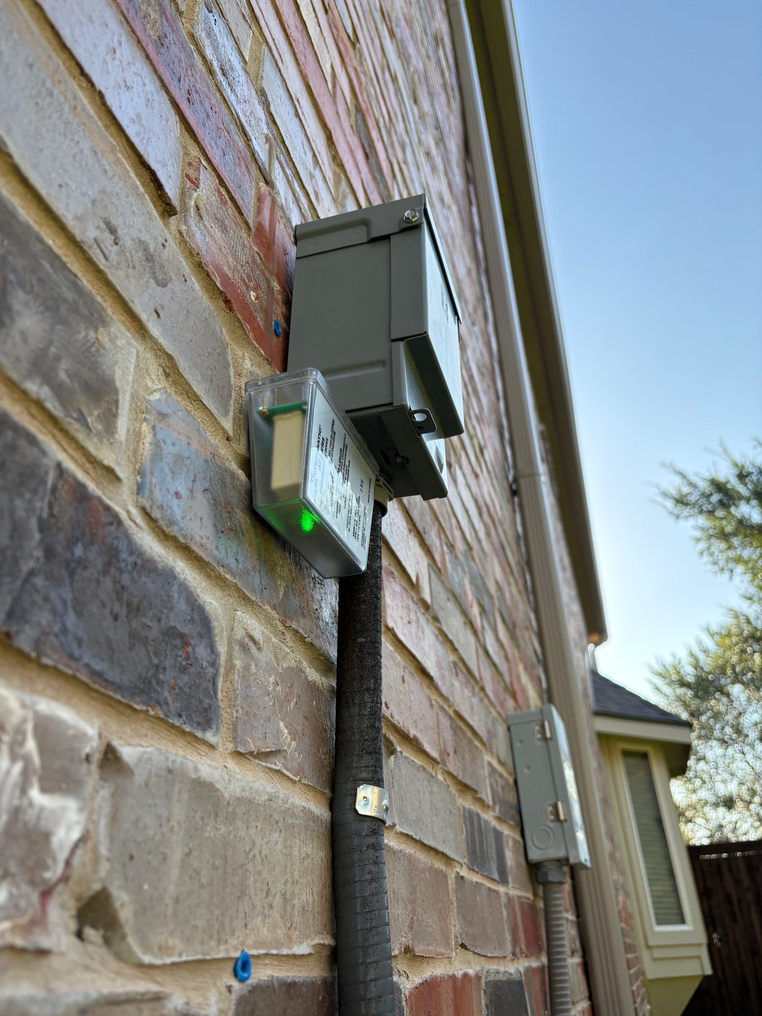 Outdoor air-conditioning unit surge protector installed by Tier-One Electric.