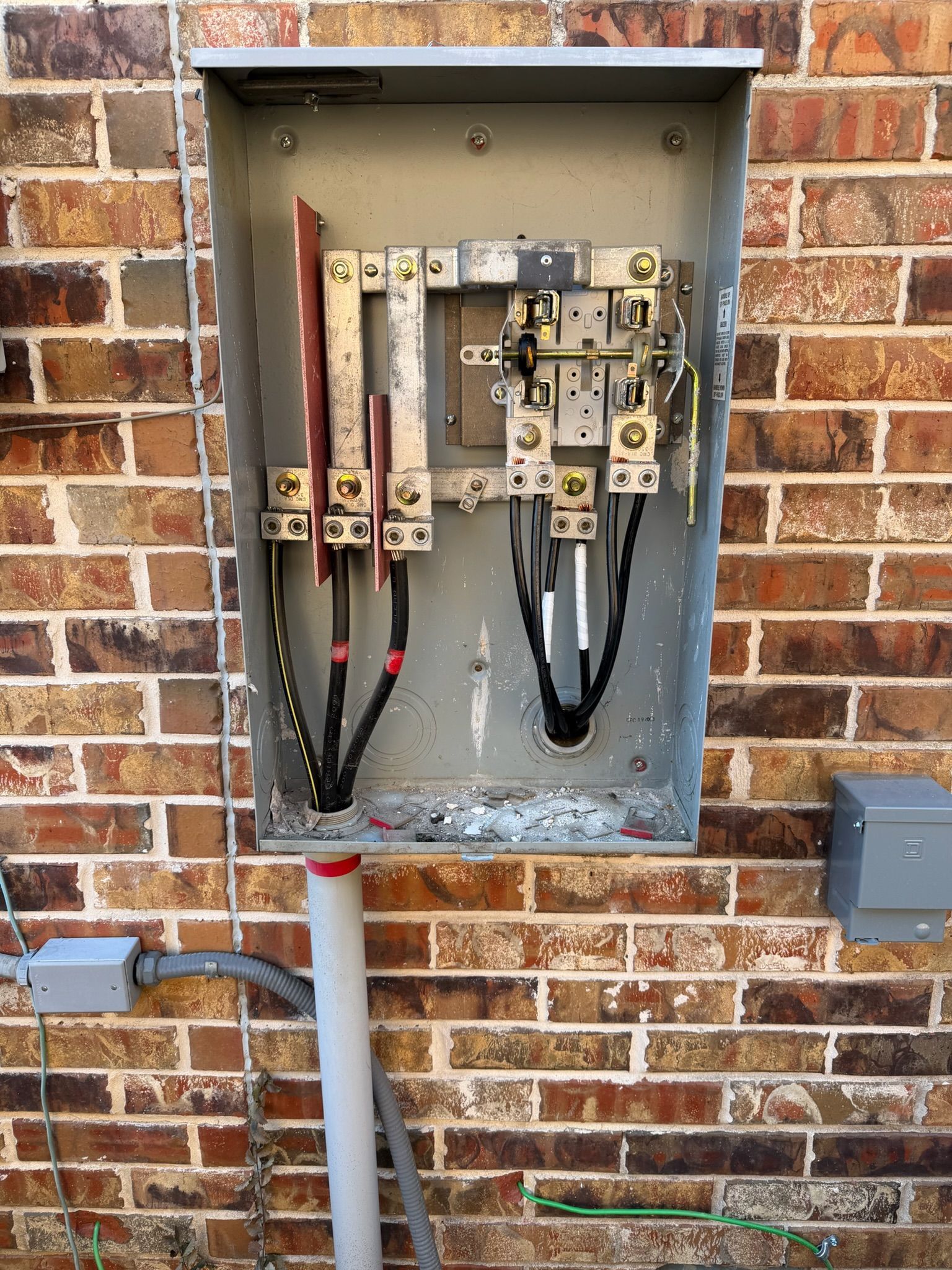 Open residential meter base during an electrical service installation by Tier-One Electric.