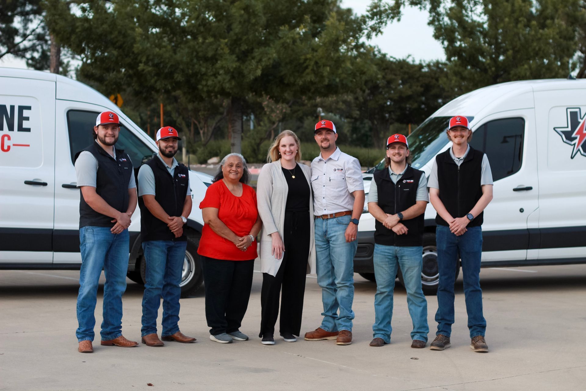 Tier-One Electric team members standing in front of electrical service vans in Grapevine, TX