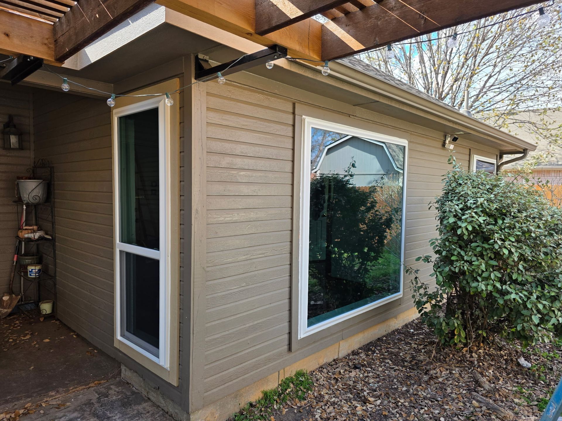 A house with a large window on the side of it.