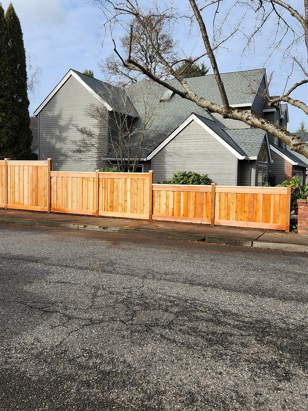 A wooden fence is sitting in front of a house